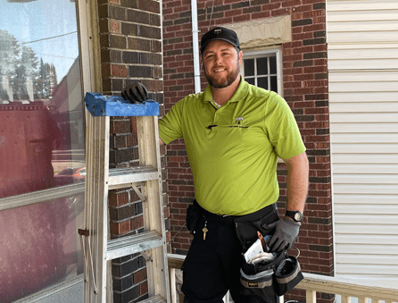 Rob Wilson standing at the front door of a house